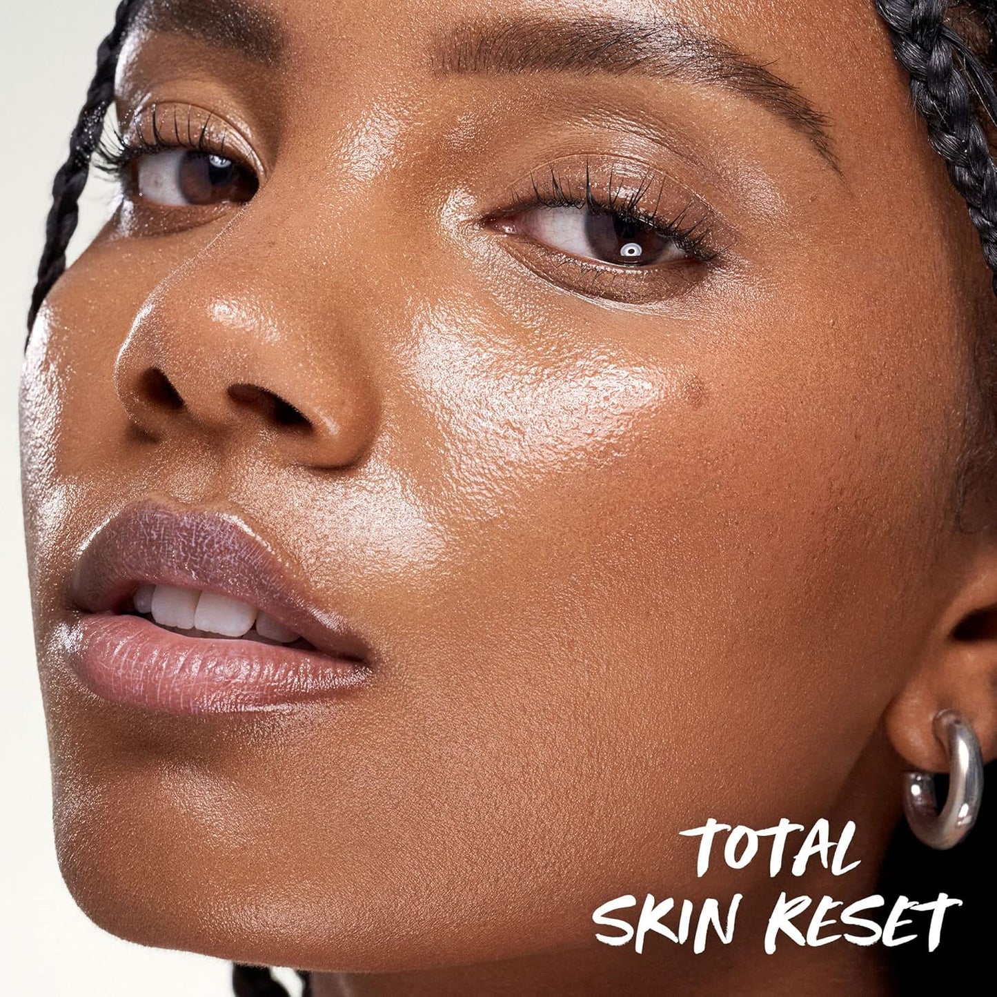 Close-up of a woman's face with 'Total Skin Reset' text