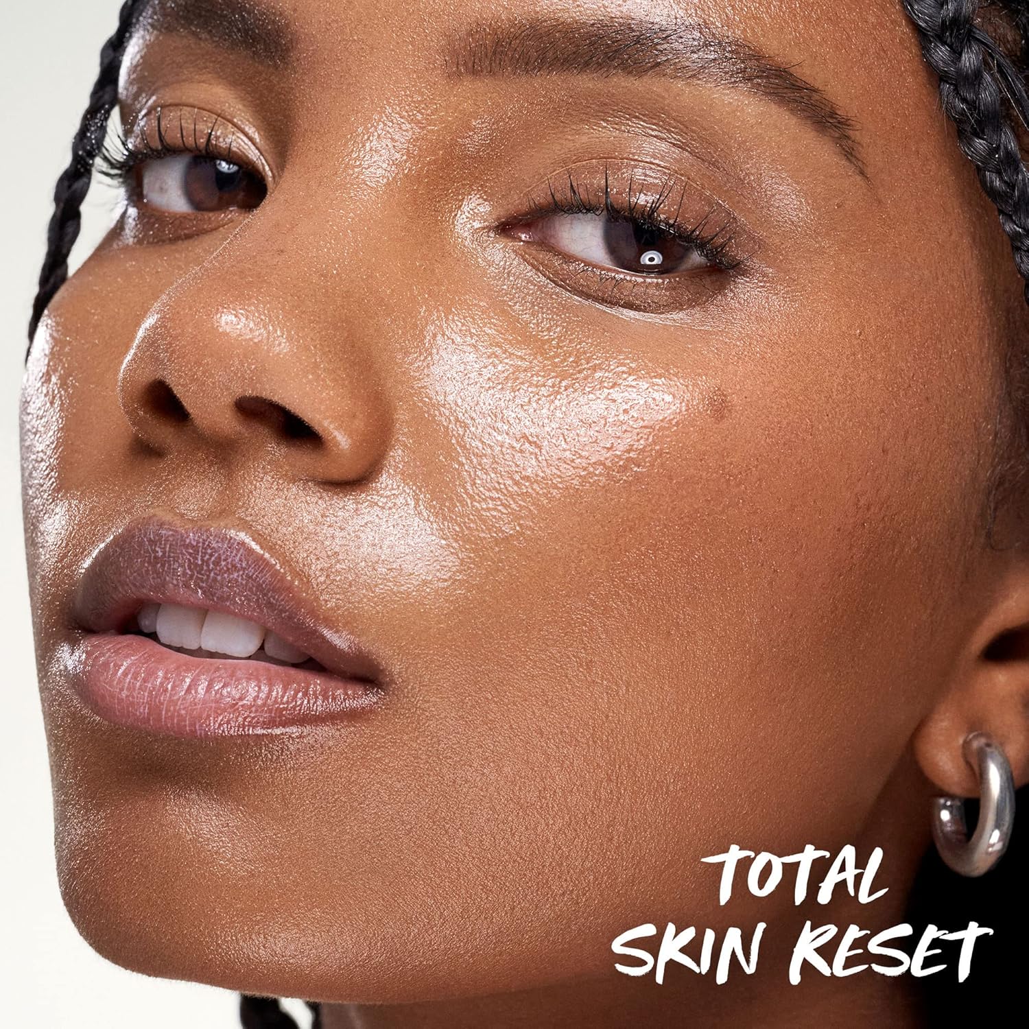 Close-up of a woman's face with 'Total Skin Reset' text