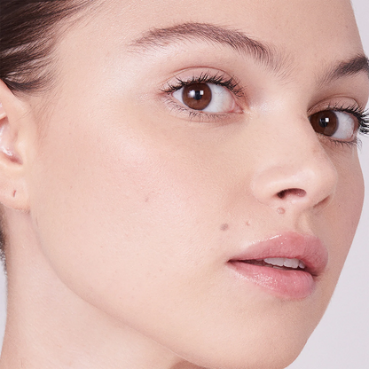 Close-up of a woman's face showing a natural, matte foundation makeup finish on her skin.