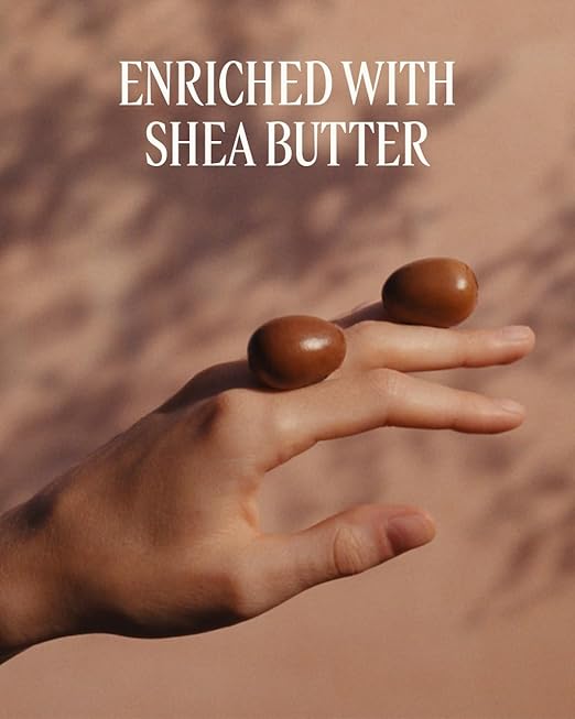 Hand balancing shea butter on a brown background with text 'Enriched with Shea Butter'.
