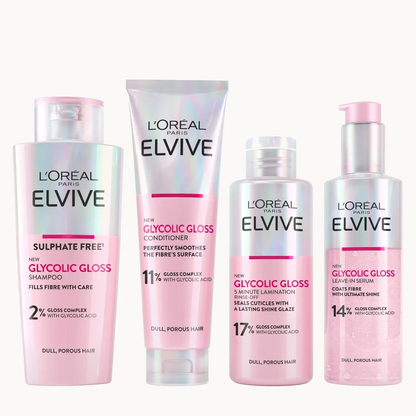 Four L'Oréal Paris L'Oréal Elvive hair care products arranged side by side on a plain white background. The set includes a shampoo bottle, a conditioner tube, a treatment bottle, and a leave-in lotion bottle, all in a soft pink and white color scheme with silver accents.