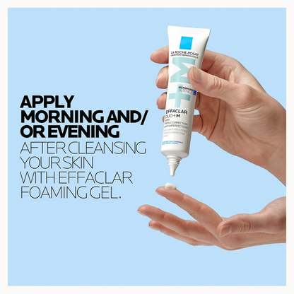 Hand holding a tube of La Roche-Posay Effaclar gel with text on a light blue background