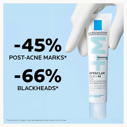 La Roche-Posay Effaclara Duo+ M skincare tube held by a white gloved hand against a light blue background with promotional text reading '-45% POST-ACNE MARKS*' and '-66% BLACKHEADS*'.