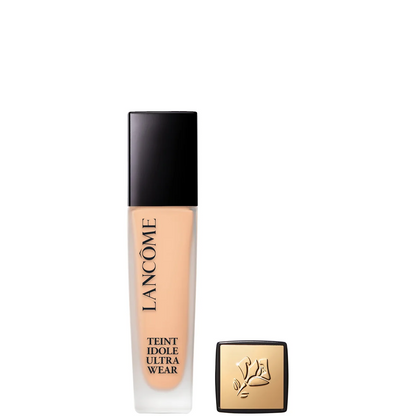 Lancôme Teint Idole Ultra Wear liquid foundation in a clear rectangular bottle showing the beige-tan shade, with a black cap and a separate gold-toned square box placed beside it on a white background.