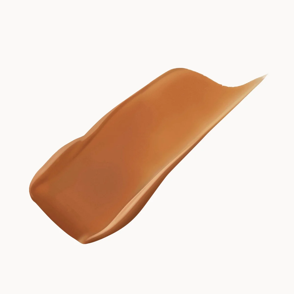 A smooth, glossy swatch of warm tan-brown cosmetic cream or foundation on a plain white background.