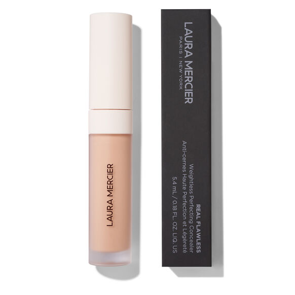 Laura Mercier Real Flawless Multi-Use Concealer in a clear tube showing the beige liquid, next to its black packaging box on a white background.