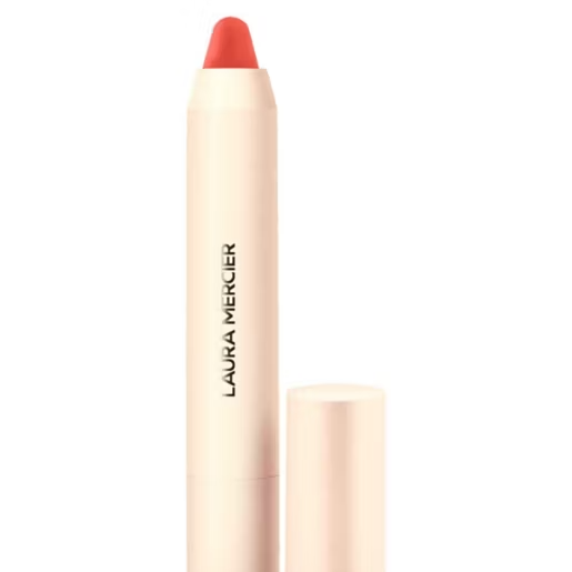 Laura Mercier lip crayon in a coral pink shade, shown with its pale pink cap off next to the tube on a white background.