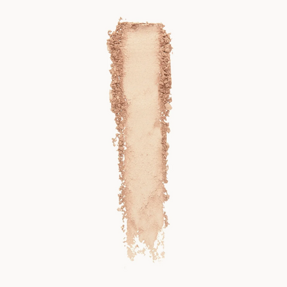 A vertical swipe of loose, finely milled makeup powder in a light warm beige-rose tone, centered on a plain white background.