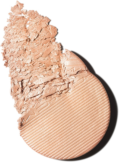 Cosmetic compact with crumbled powder on a white background