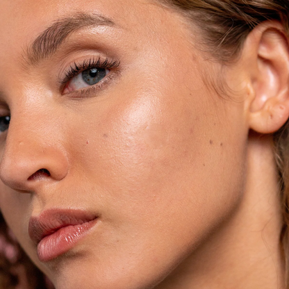 Close-up of a woman's face with a soft focus on her eye and ear