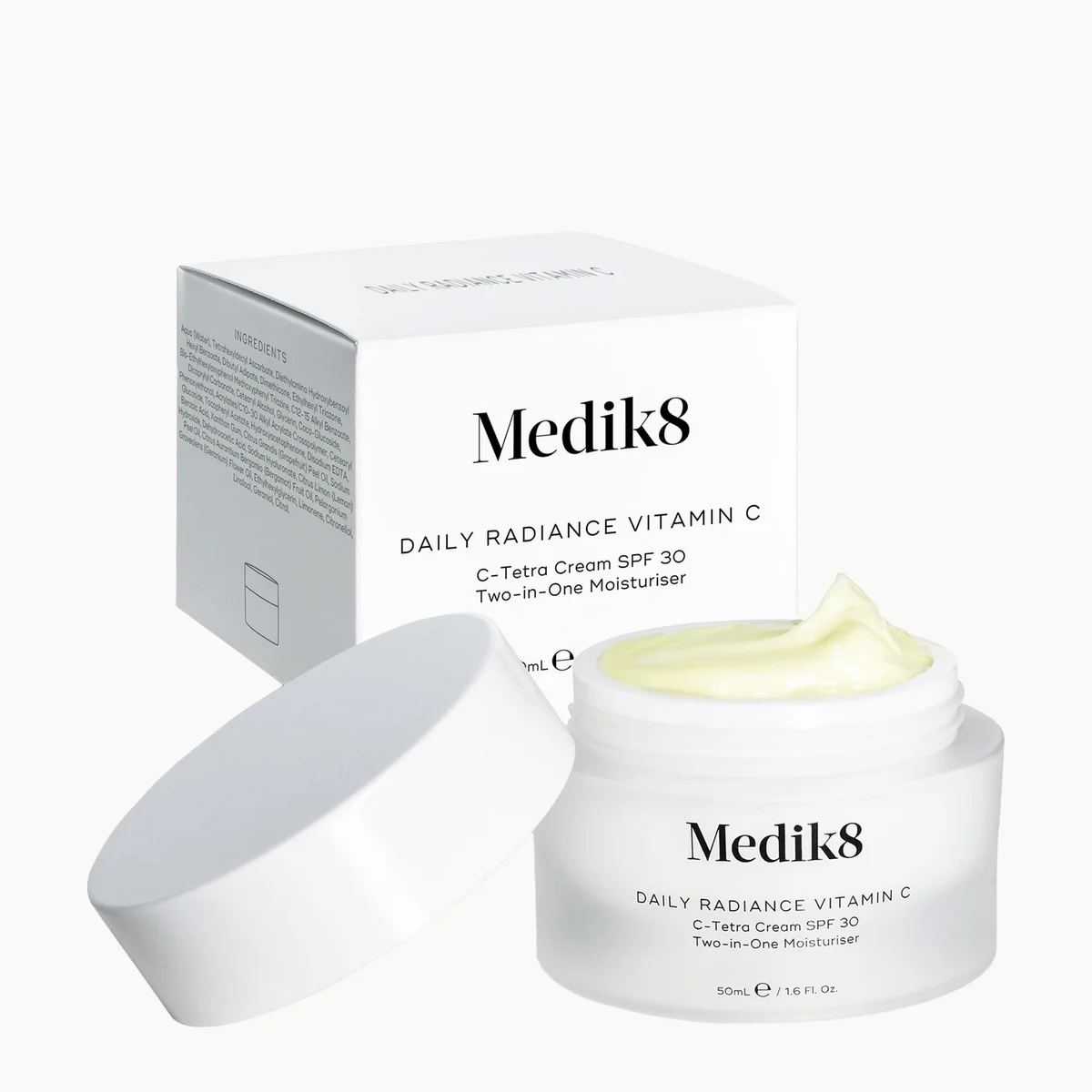 Medik8 Daily Radiance Vitamin C C-Tetra Cream SPF 30 jar with its white lid in front and the white product box behind, on a clean white background.