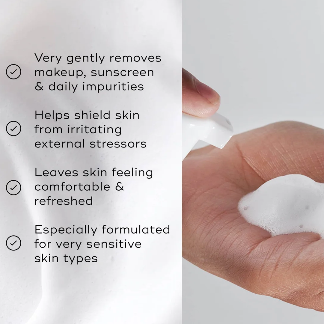 Product packaging with text about skincare benefits and a hand holding the product.