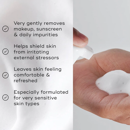 Product packaging with text about skincare benefits and a hand holding the product.