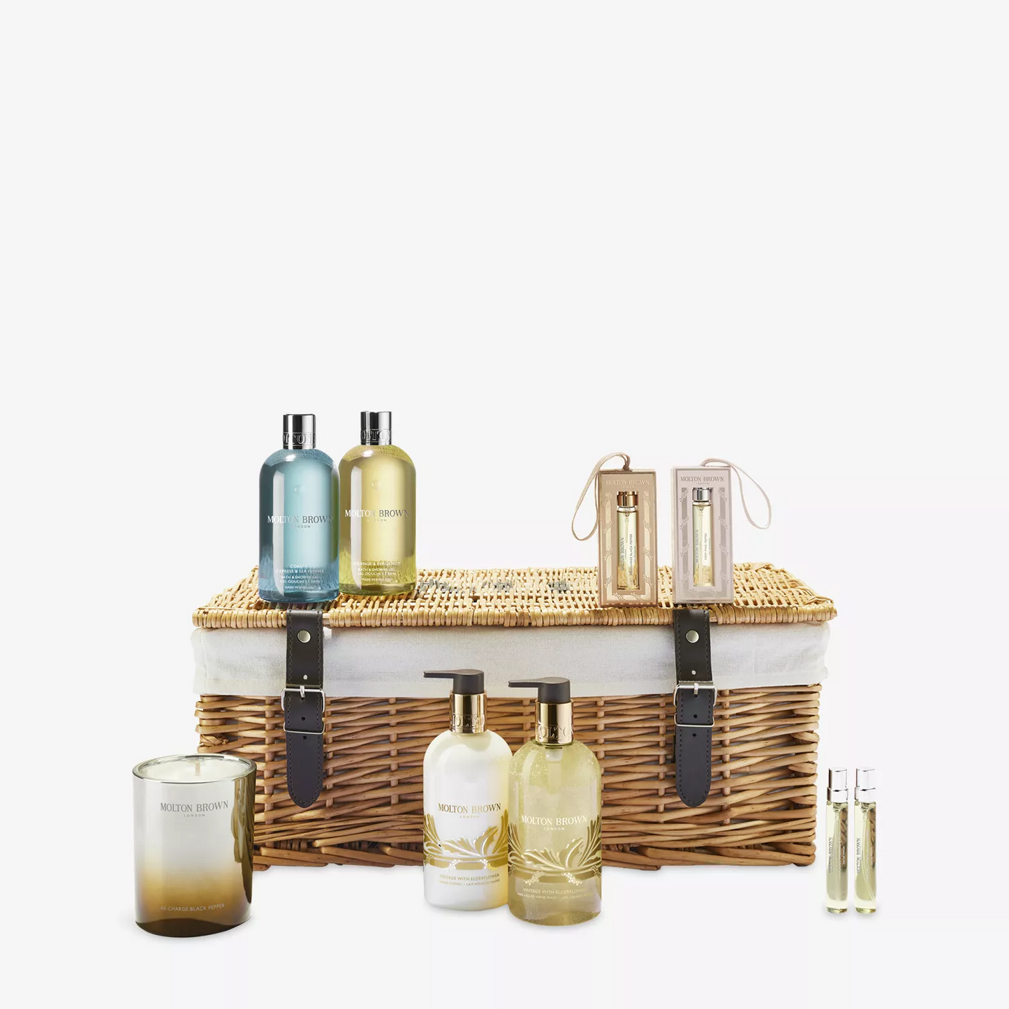 Set of Molton Brown skincare products and a wicker basket on a white background