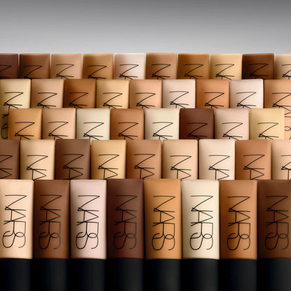 NARS makeup products arranged in a pattern with a gray background
