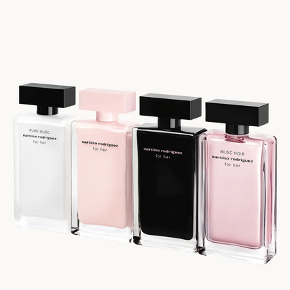 Four rectangular perfume bottles for her by Marc Jacobs, shown in white, pale pink, black, and dusty pink glass with black caps on a clean white background.