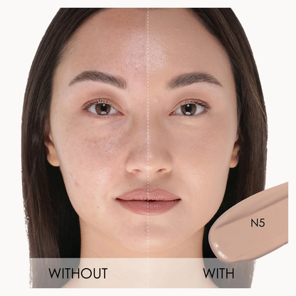 A close-up before-and-after comparison of a woman's face showing makeup application, with a beige makeup swatch labeled N5 on the right and text reading WITHOUT and WITH across the bottom.