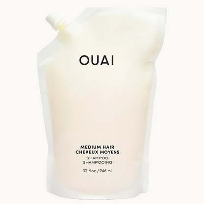 A refill pouch of OUAI Medium Hair Shampoo, filled with a creamy off-white liquid, shown against a plain white background.