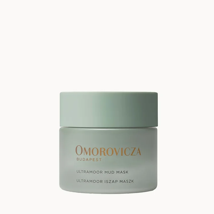 A jar of Omorovicza Ultrafine Mud Mask in a pale sage green color, centered on a solid white background.