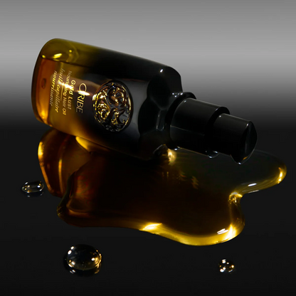 Olivier Rousteing's bottle of Creme de la Creme on a reflective surface with a dark background