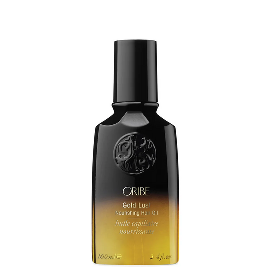 A bottle of Oribe Gold Lust Nourishing Hair Oil, featuring a black-to-gold gradient bottle with a black cap, set against a plain white background.