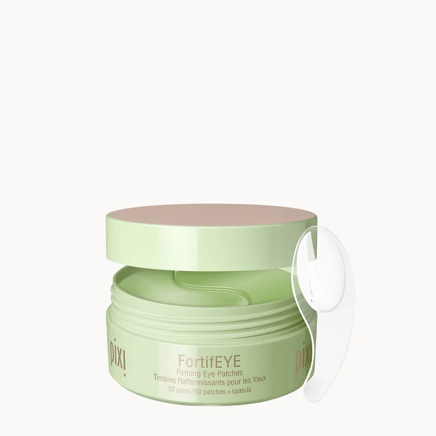 A light green jar of FortiEye Piling Eye Cream with a matching lid and a clear plastic applicator loop, set against a solid off-white background.