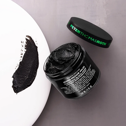 Black facial mask in a jar with 'Peter Thomas Roth' branding on a gray background