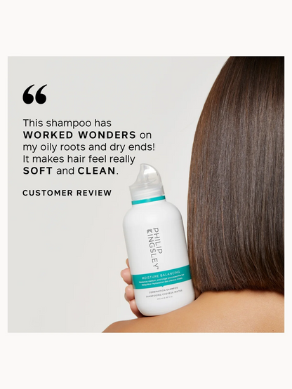 Shampoo bottle held by a person with long hair, featuring a customer review quote.