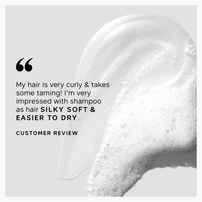 Close-up of shampoo with a customer review text overlay on a light gray background