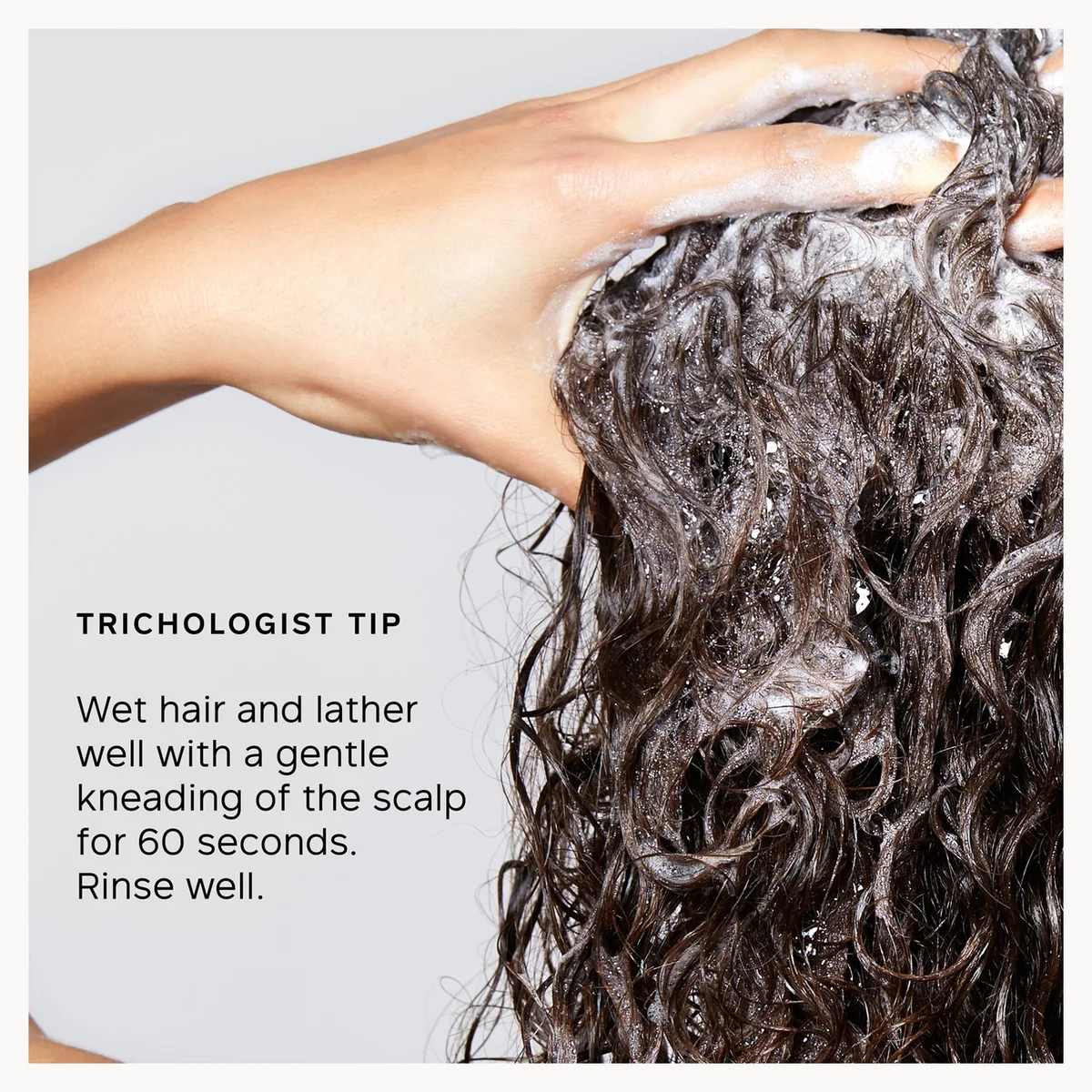 Person washing hair with a trichologist tip instruction on a light gray background
