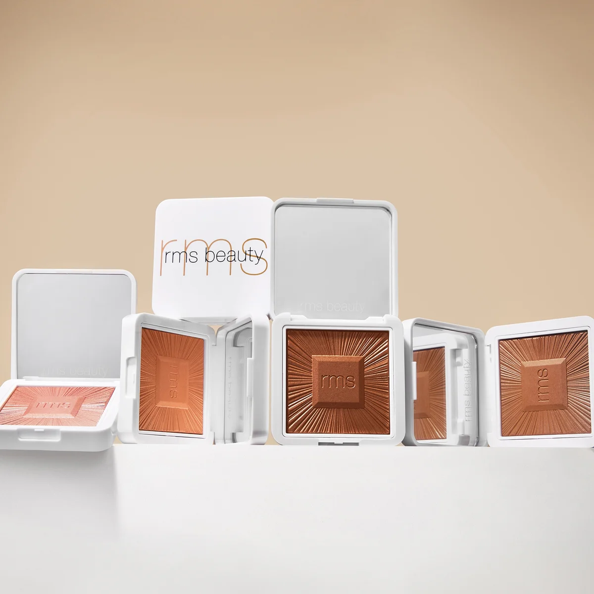 RMS Beauty makeup products with visible brand logo on a beige background