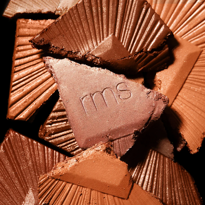Close-up of chocolate pieces with 'rms' branding.