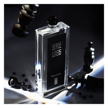 Serge Lutens perfume bottle with chess pieces on a dark background