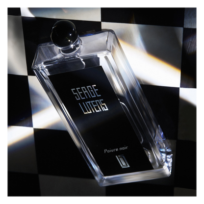 Perfume bottle with 'Serge Lutens' branding on a checkered background
