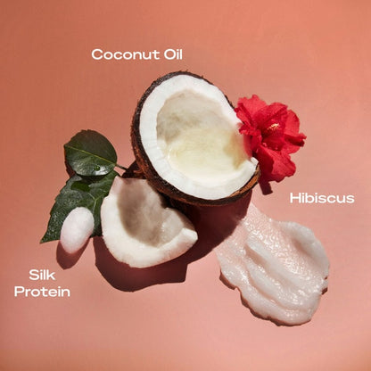Coconut, hibiscus flower, and silk protein on a peach background with text labels.