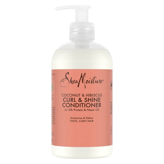 A bottle of SheaMoisture Coconut & Hibiscus Curl & Shine Conditioner with a white pump dispenser and a coral pink label, shown against a plain white background.