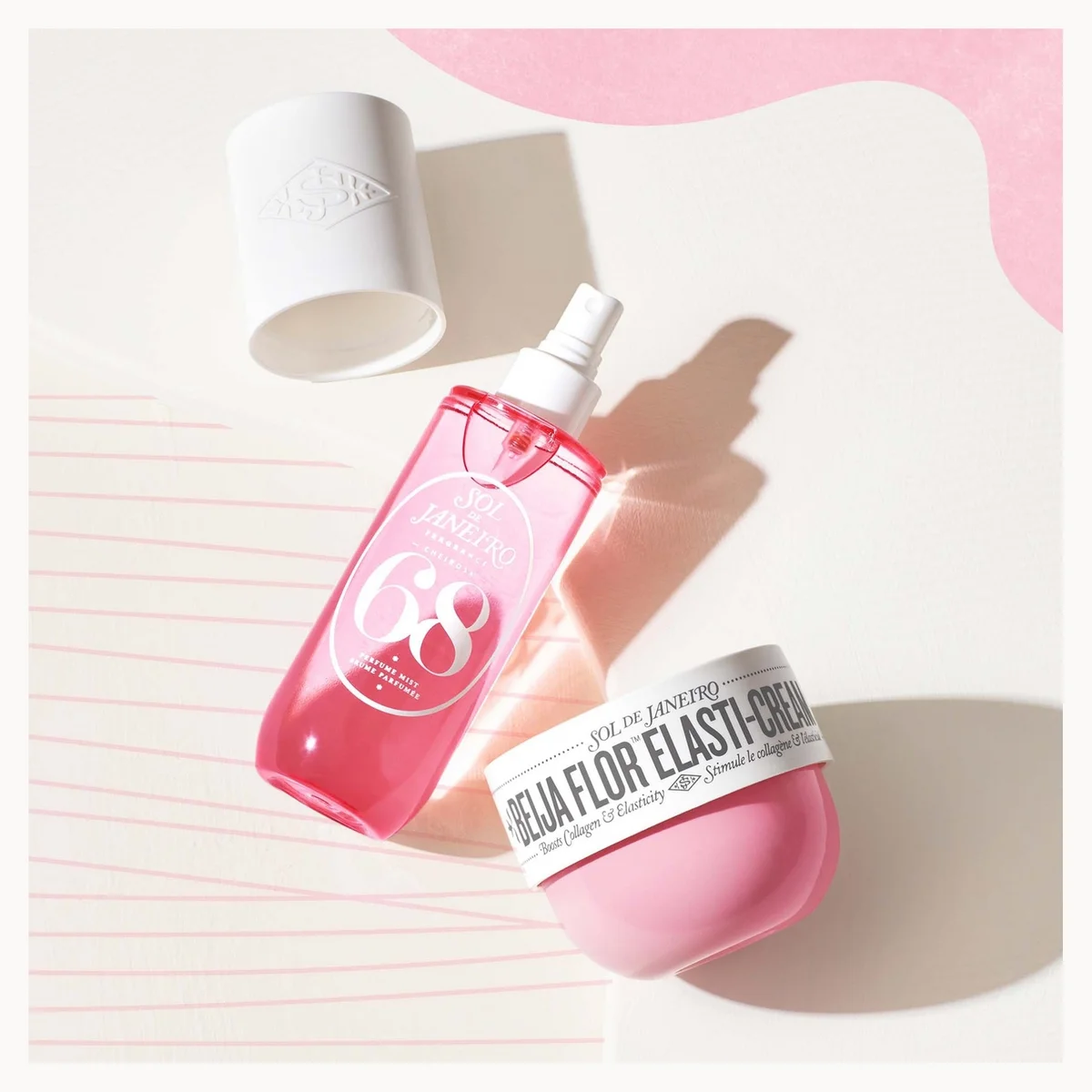 A pink bottle of facial serum and a pink cream jar with a white label, styled on a light beige background with pink wavy accents and soft shadows.