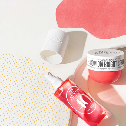 A flat-lay product shot of a red and white Dr. Jack's '80M Dia Bright Cream set, featuring a red spray bottle and a white cream jar with its cap off, styled on a white background with abstract pink and yellow polka-dot paper shapes.