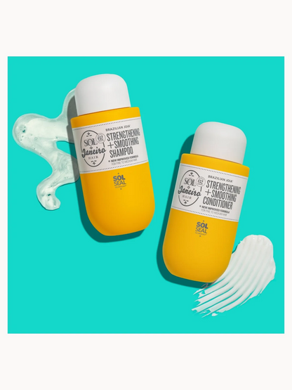 Yellow shampoo and conditioner bottles with white caps on a teal background