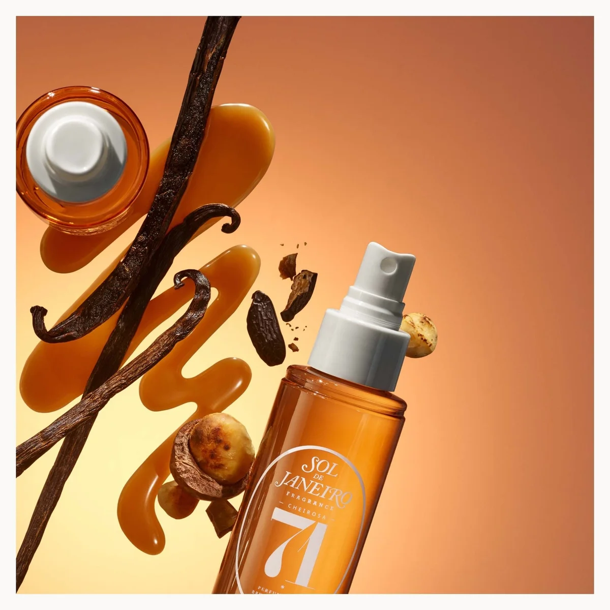 A bottle of Sol-de-Janeiro-Cheirosa 71% Vanilla Bean Hair and body mist shown with floating vanilla beans, vanilla extract, and vanilla seeds against a warm orange gradient background.