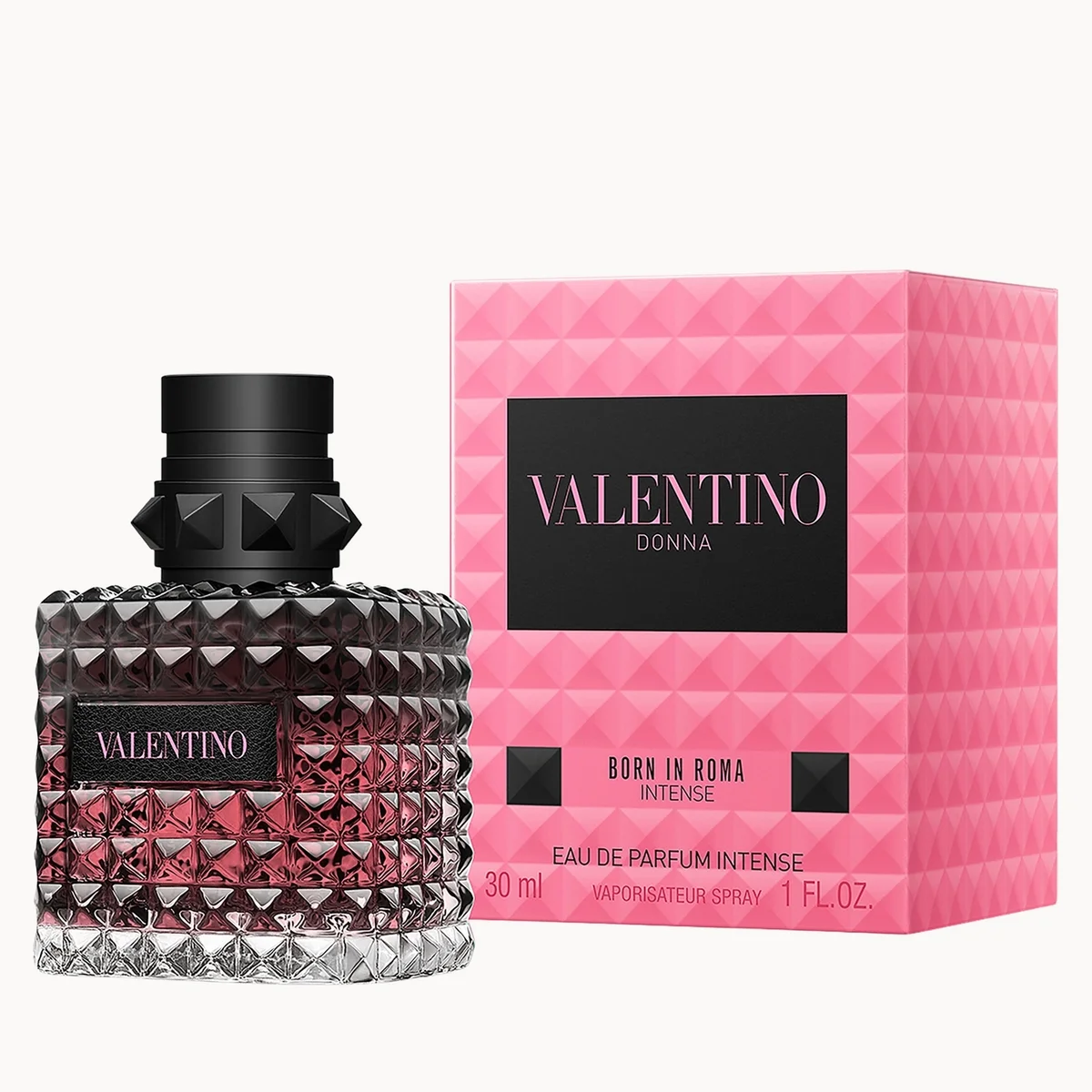 Valentino Donna Born in Roma Intense Eau de Parfum spray bottle next to its pink patterned retail box on a white background.