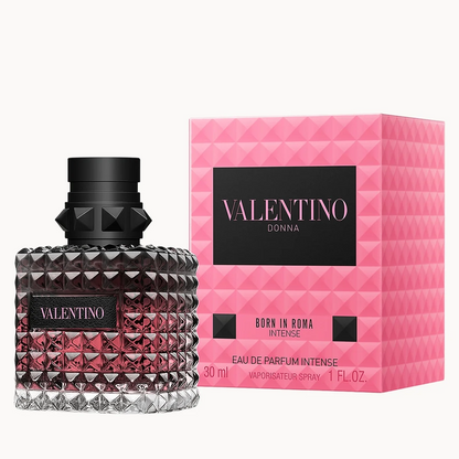 Valentino Donna Born in Roma Intense Eau de Parfum spray bottle next to its pink patterned retail box on a white background.