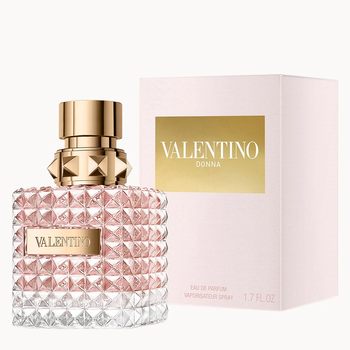 Valentino Donna Eau de Parfum bottle with a textured pink and clear diamond-patterned glass body and a gold cap, shown next to its light pink and gold box.