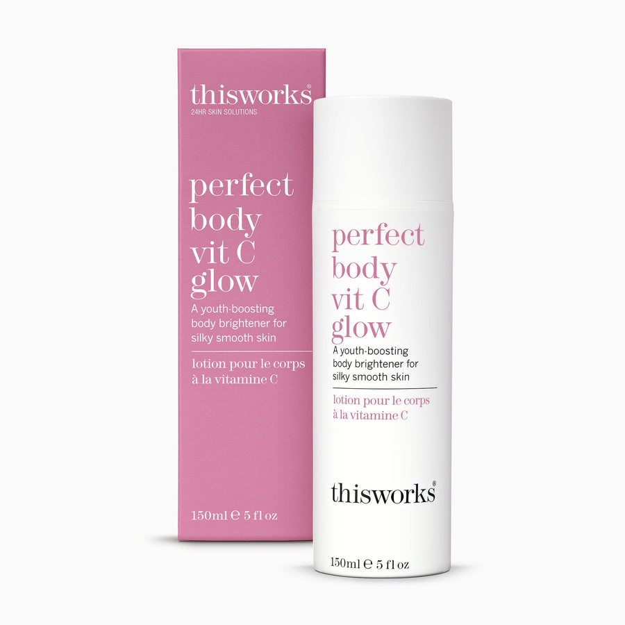 Thisworks Perfect Body Vit C Glow body brightener shown as a white pump bottle next to its pink packaging box on a light gray background.
