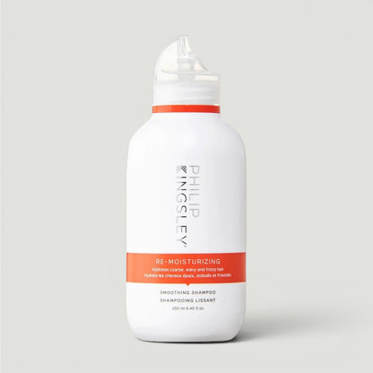 White Philip Kingsley Re-Moisturizing Smoothing Shampoo bottle with red label on a light gray background
