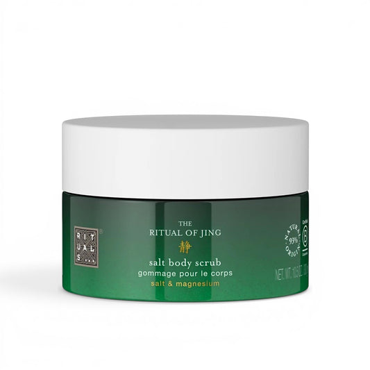 Green jar of salt body exfoliating scrub with white lid on a white background